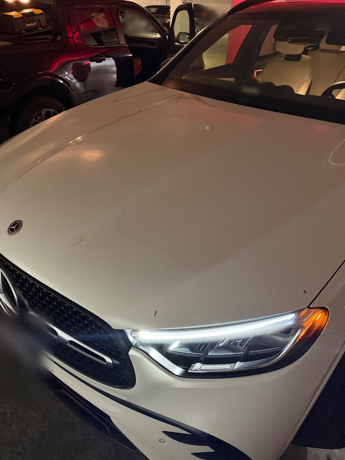 Front hood of a white Mercedes GLC before washing, spotted with bird droppings and bug splatter