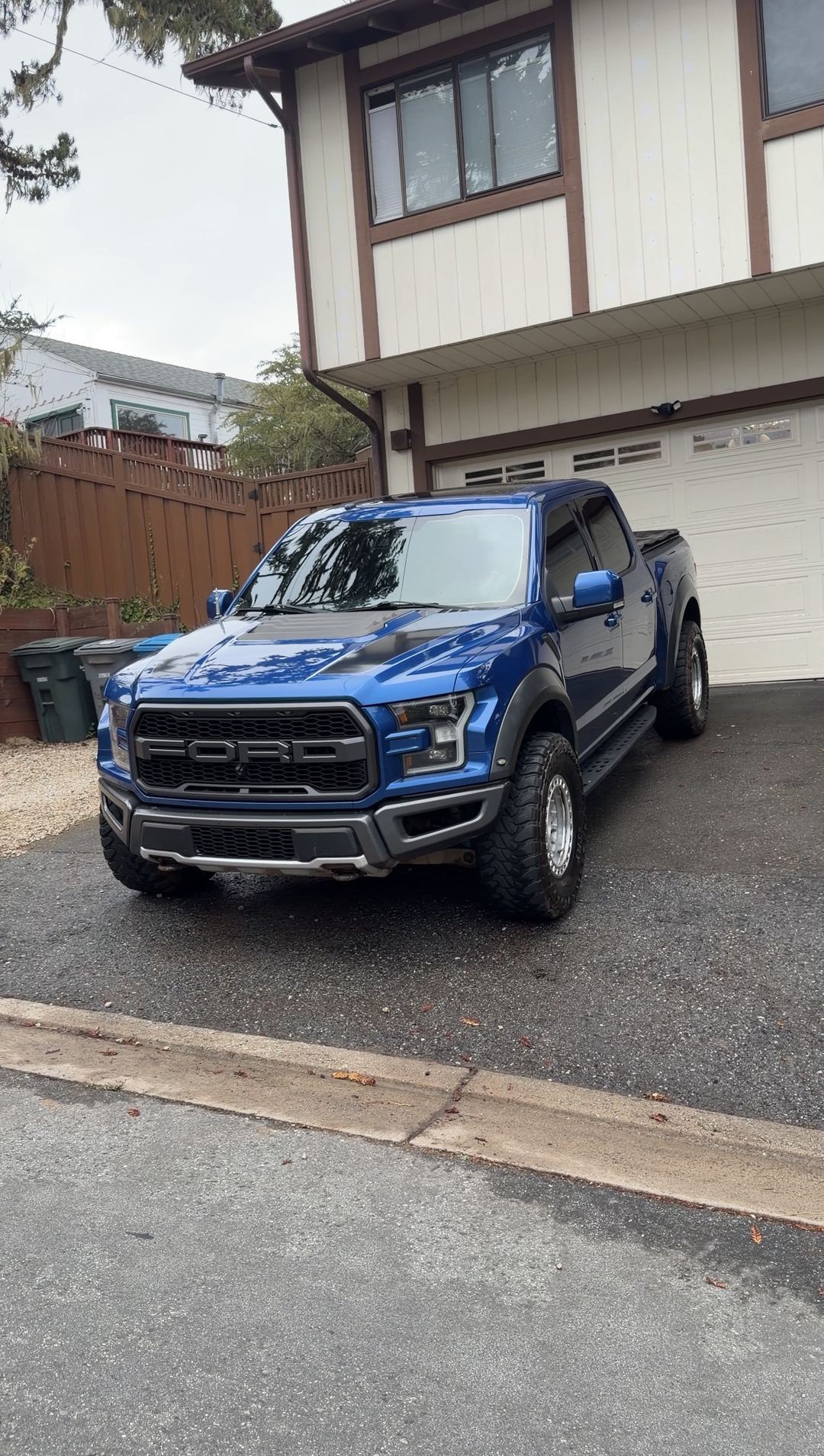 Clean blue Ford F-150 Raptor on a driveway after a mobile detail