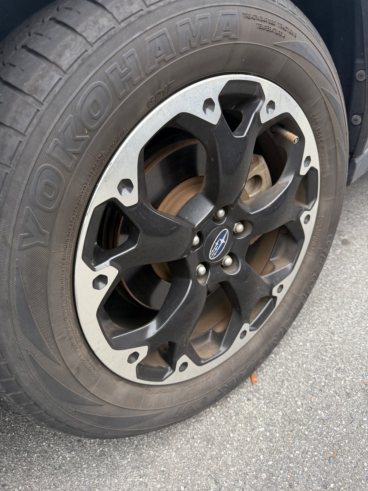 Front wheel of a white Subaru Crosstrek in the Inner Richmond, San Francisco, before detailing