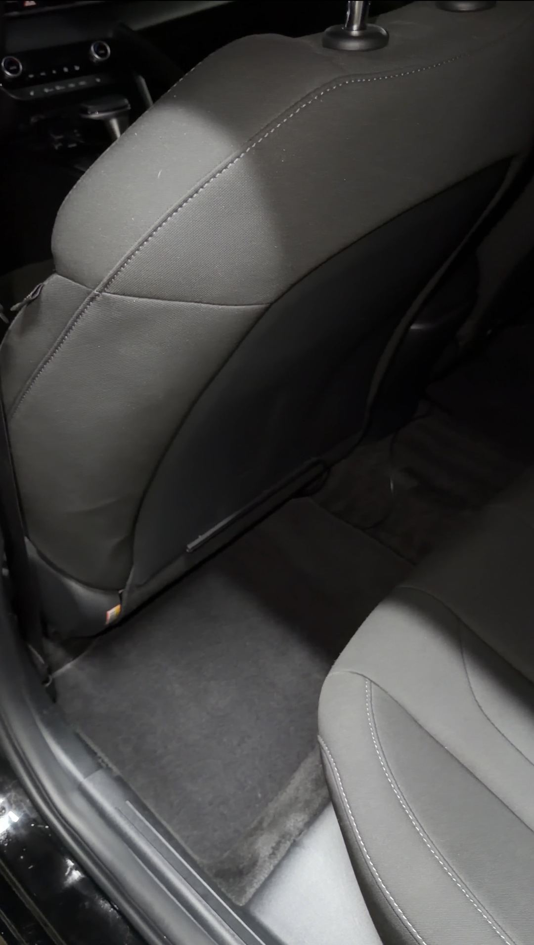 Clean rear footwell mat behind the front seat of a Hyundai Elantra