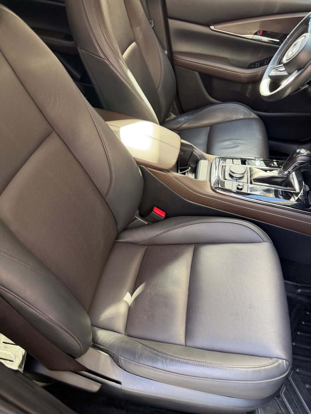 Front passenger seat of a grey Mazda CX-30 after detailing, clean leather