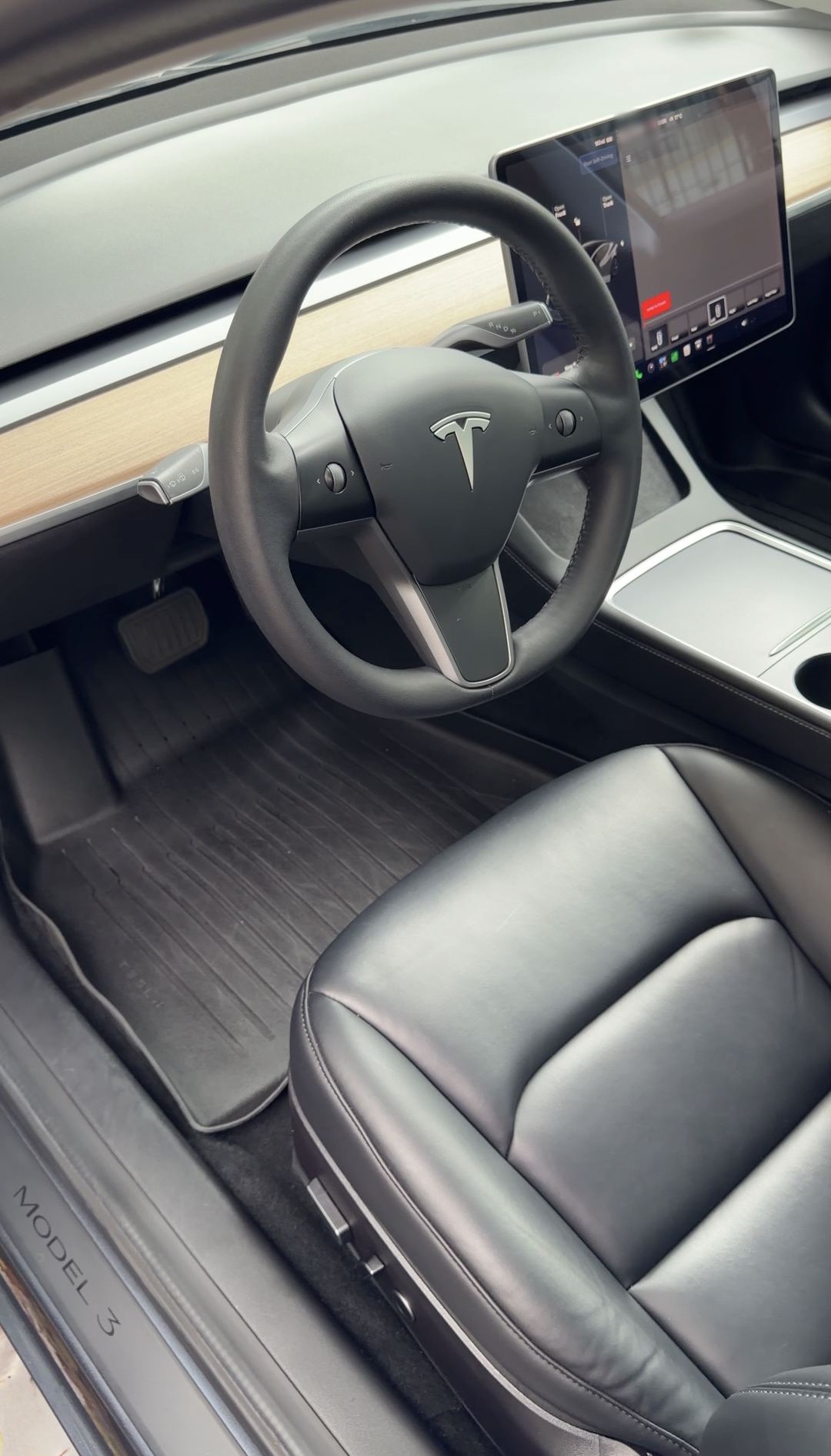 Tesla Model 3 driver footwell after cleaning, clean rubber mat, carpet and MODEL 3 sill plate
