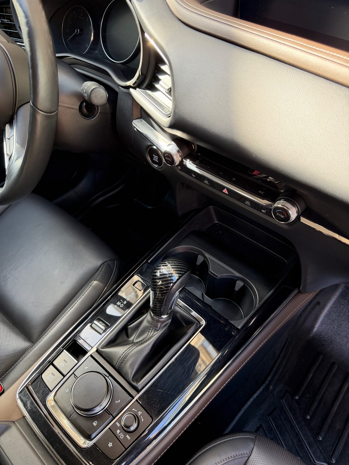Centre console of a grey Mazda CX-30 after detailing, trim clean