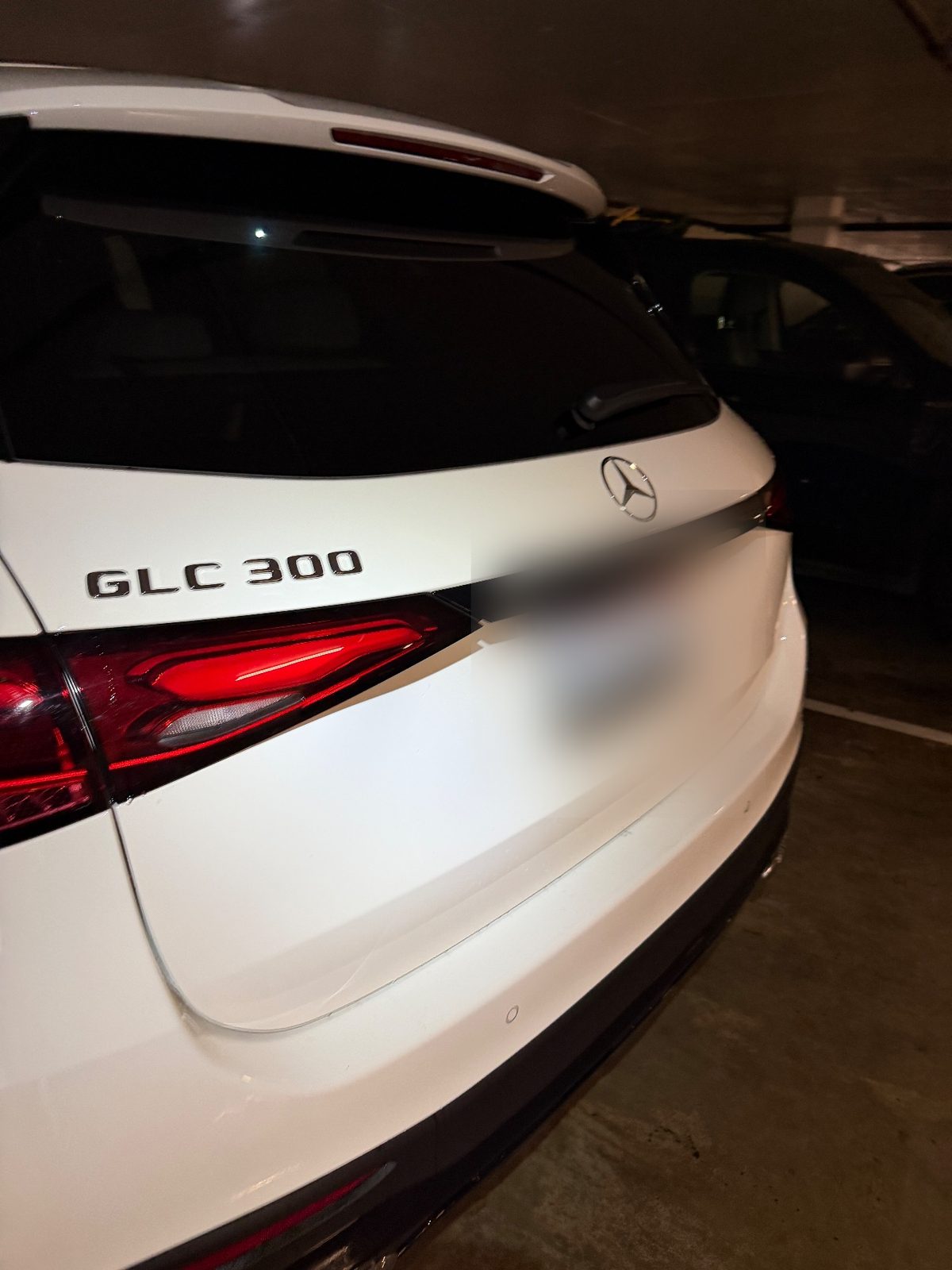 Rear of a white Mercedes-Benz GLC 300 after detailing, tailgate badge and tail lights