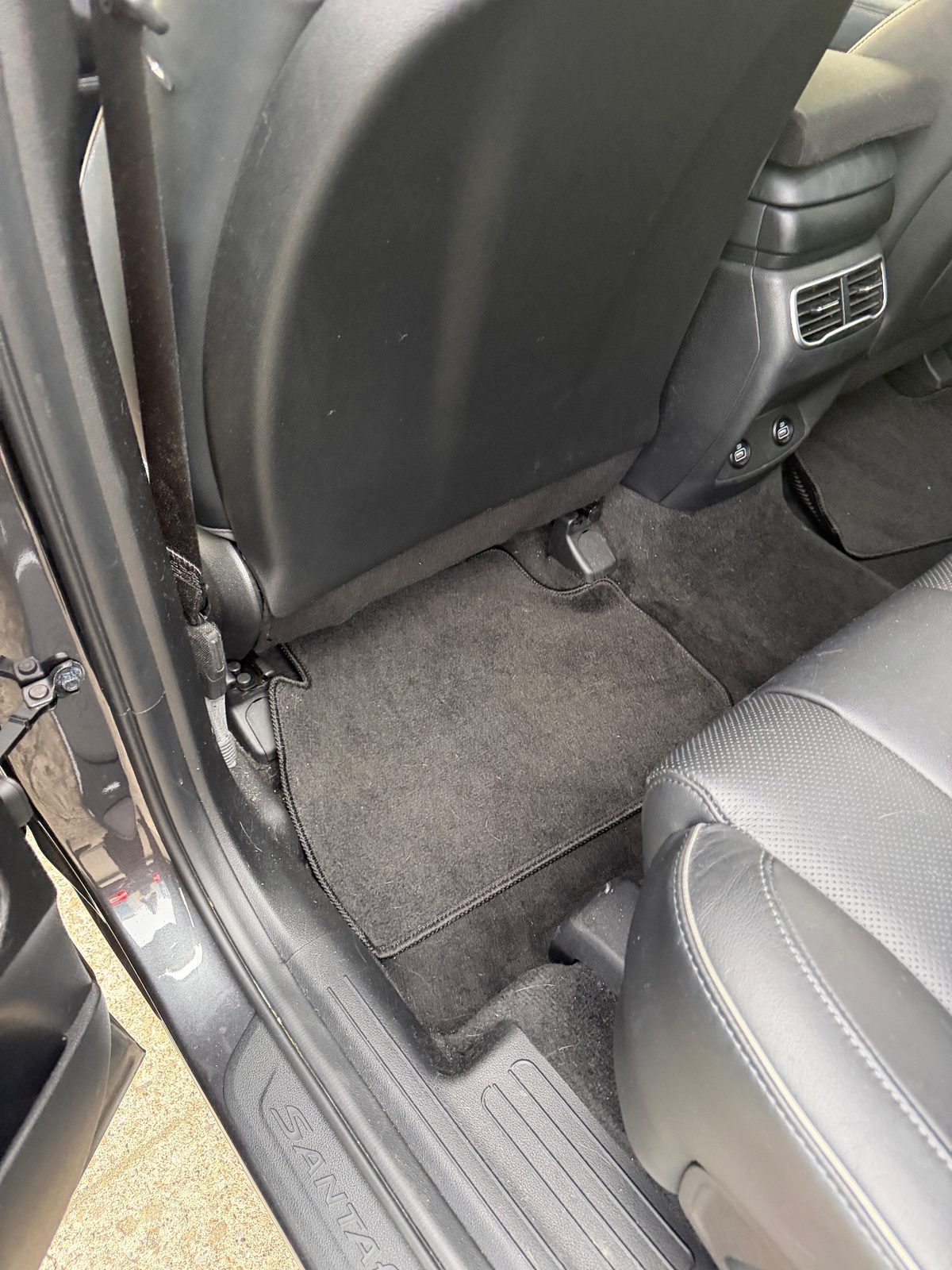 Rear footwell carpet of a Hyundai Santa Fe before detailing, with lint and grit