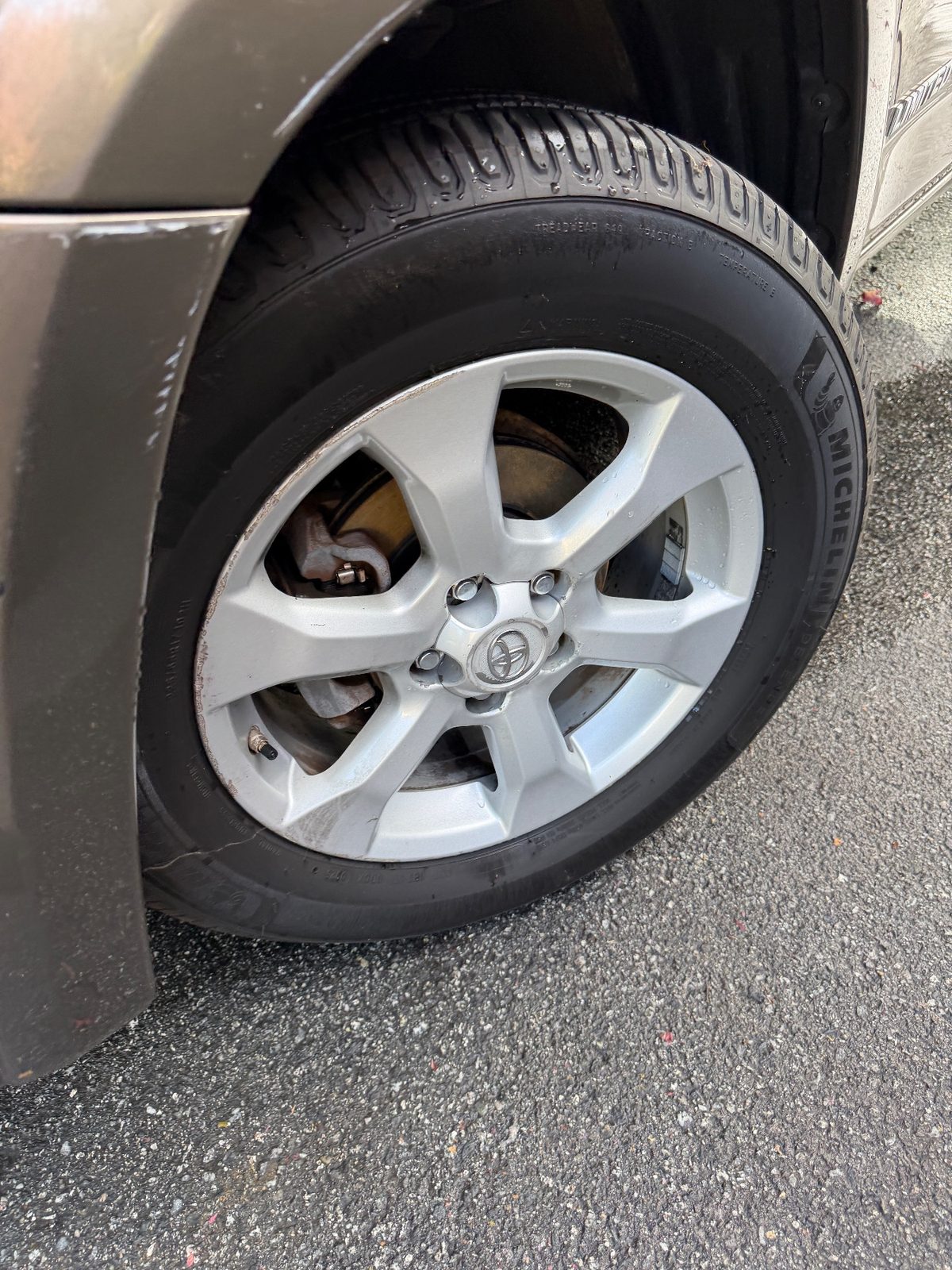 Front wheel and fender of a bronze Toyota RAV4 in the Inner Sunset, San Francisco, after detailing