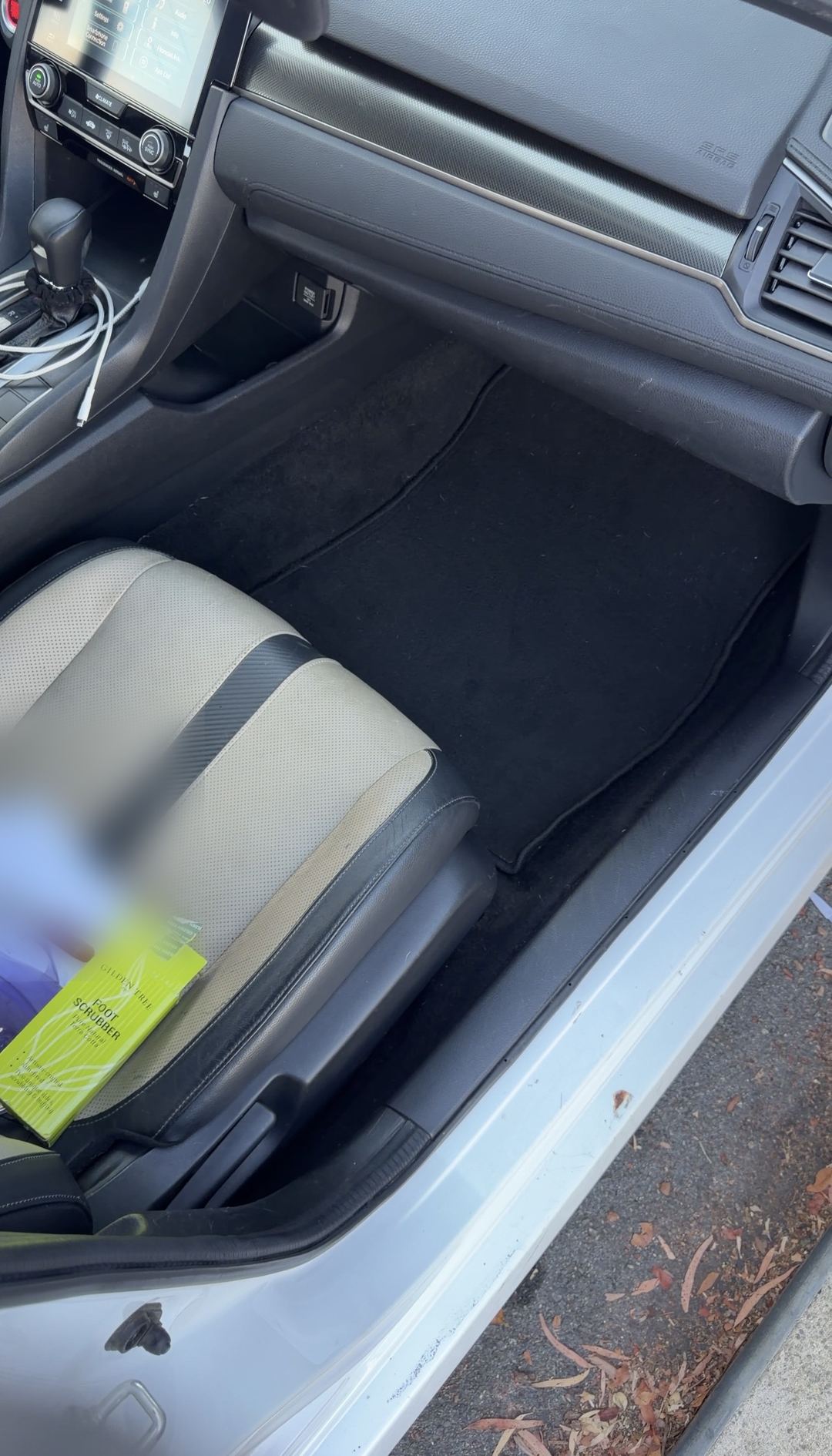 Clean front passenger footwell of a Honda Civic after interior detailing