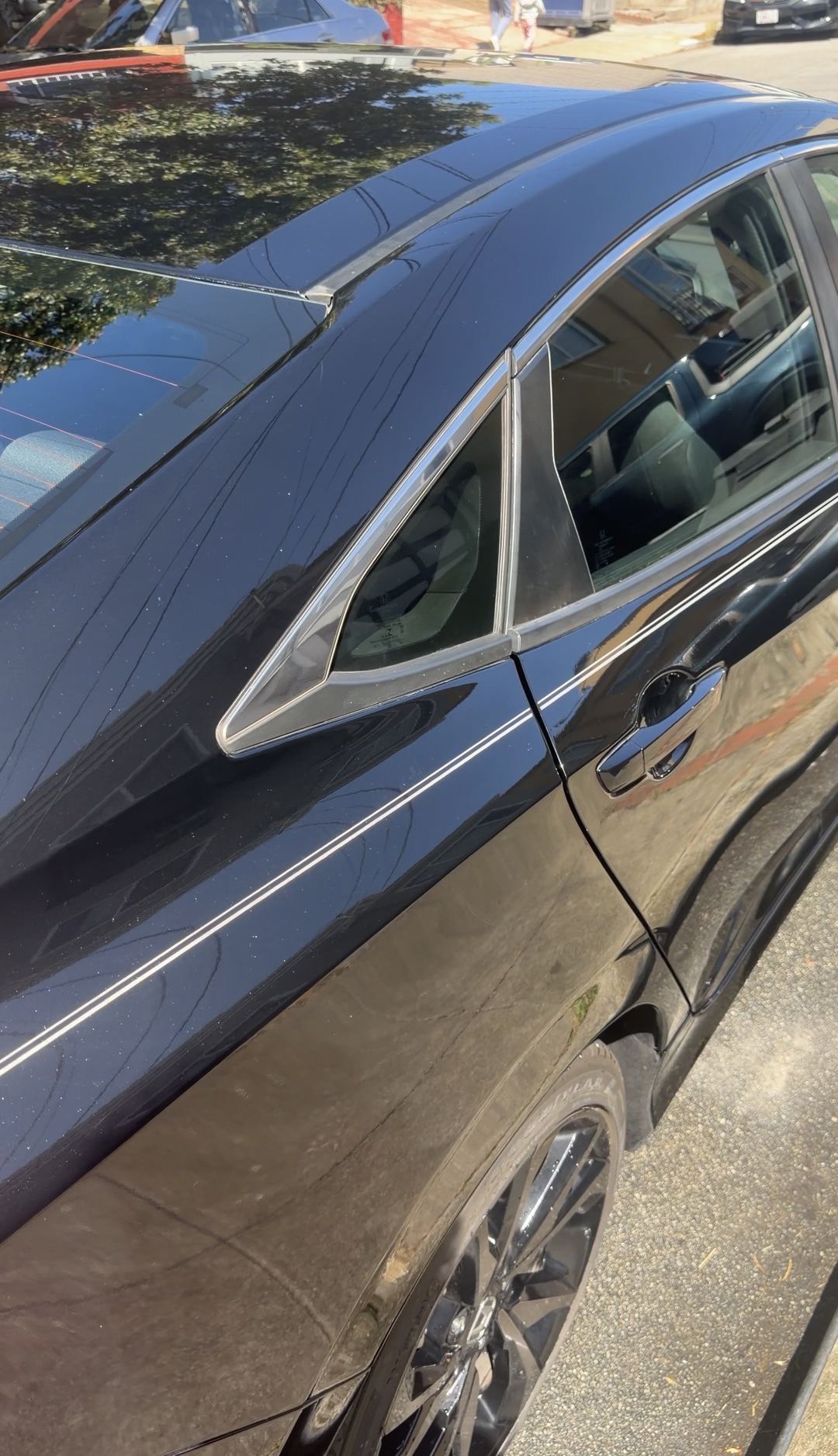 Glossy driver-side doors of a black Honda Civic after the detail