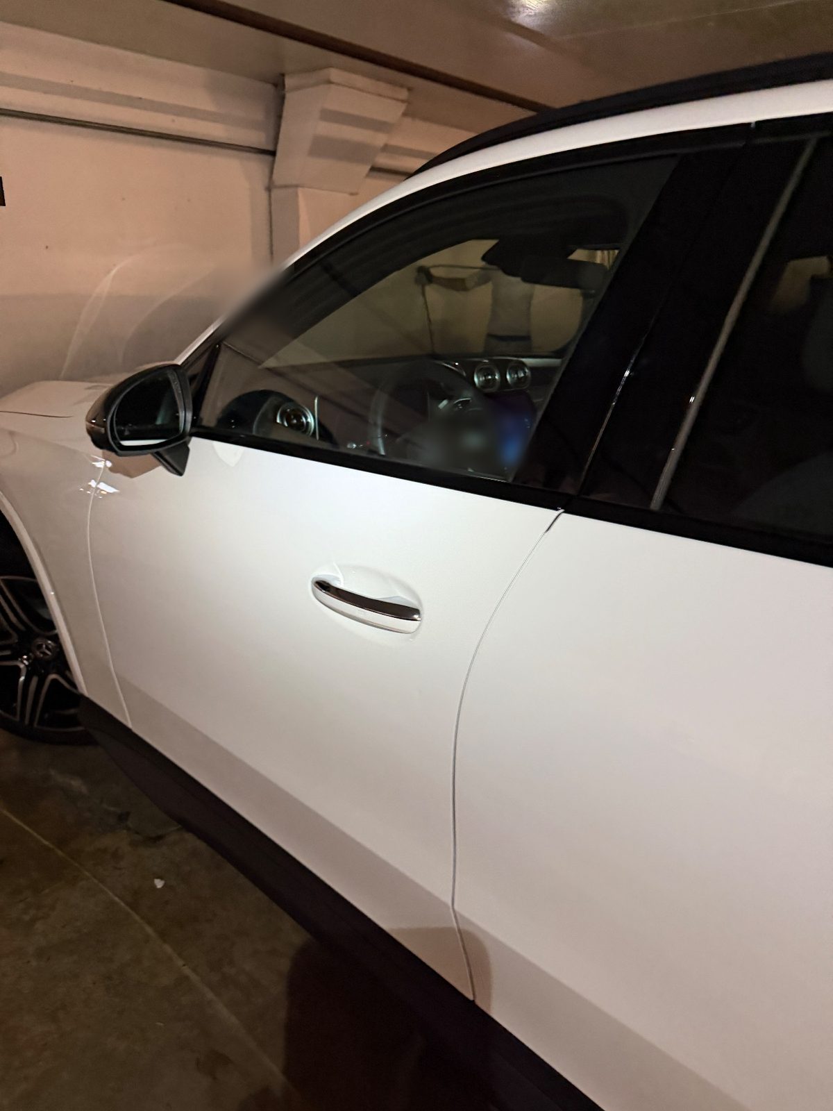 Front door and mirror of a white Mercedes GLC after washing, clean white paint