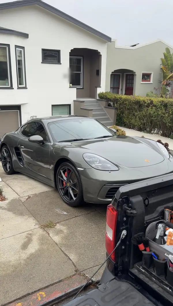 Green Porsche 718 Cayman S gleaming on a San Francisco driveway after a full mobile detail.