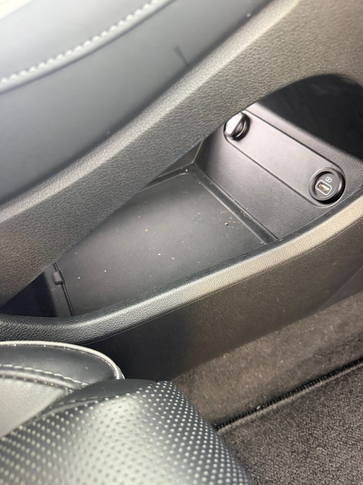 Under-dash storage tray of a Hyundai Santa Fe before detailing