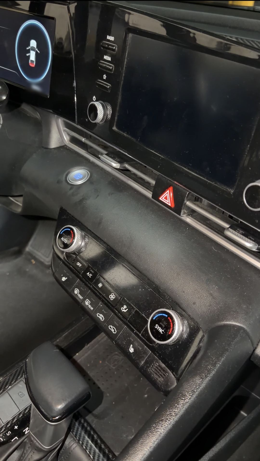 Hyundai Elantra centre stack and climate controls with dust on the trim before cleaning