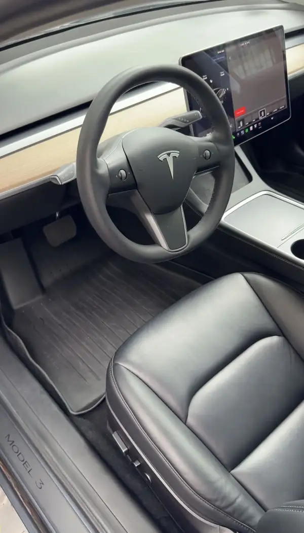 Tesla Model 3 driver footwell after cleaning, clean rubber mat, carpet and MODEL 3 sill plate