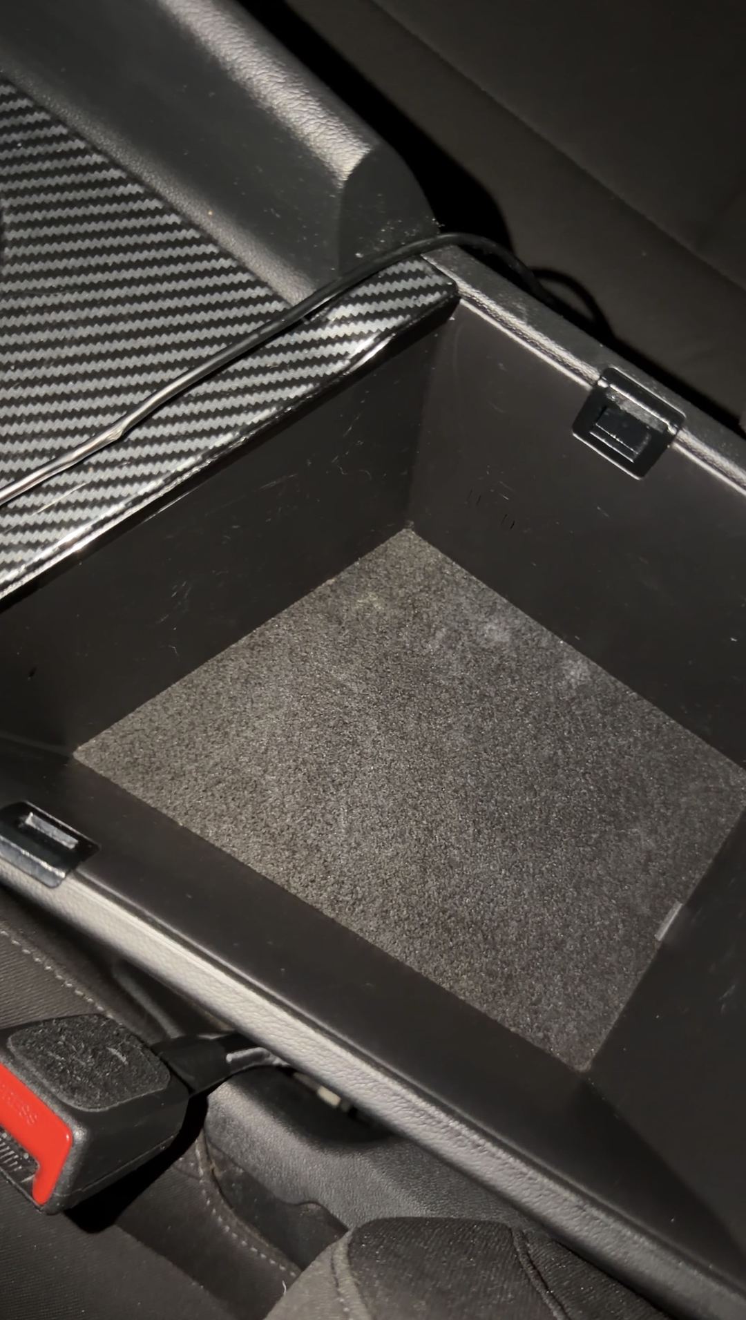 Clean felt floor of the armrest storage bin in a Hyundai Elantra after cleaning