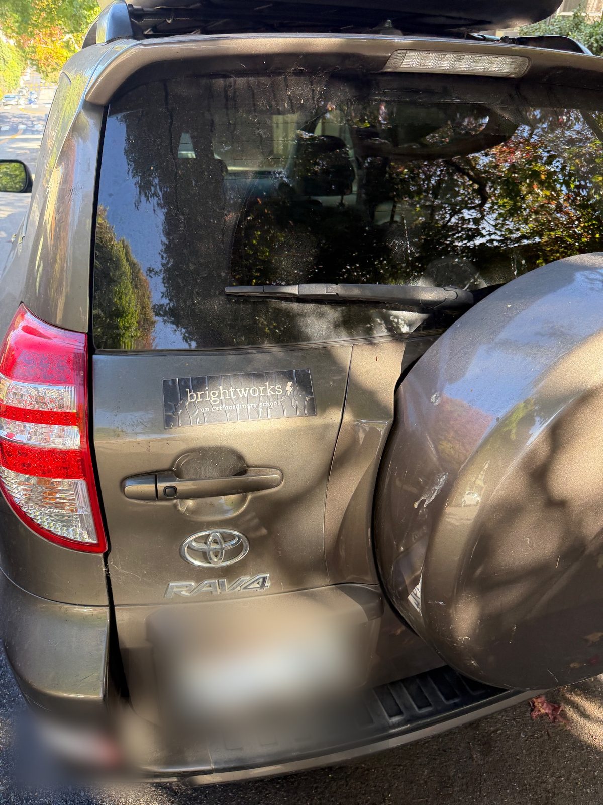 Dusty rear tailgate of a 2011 Toyota RAV4 before washing