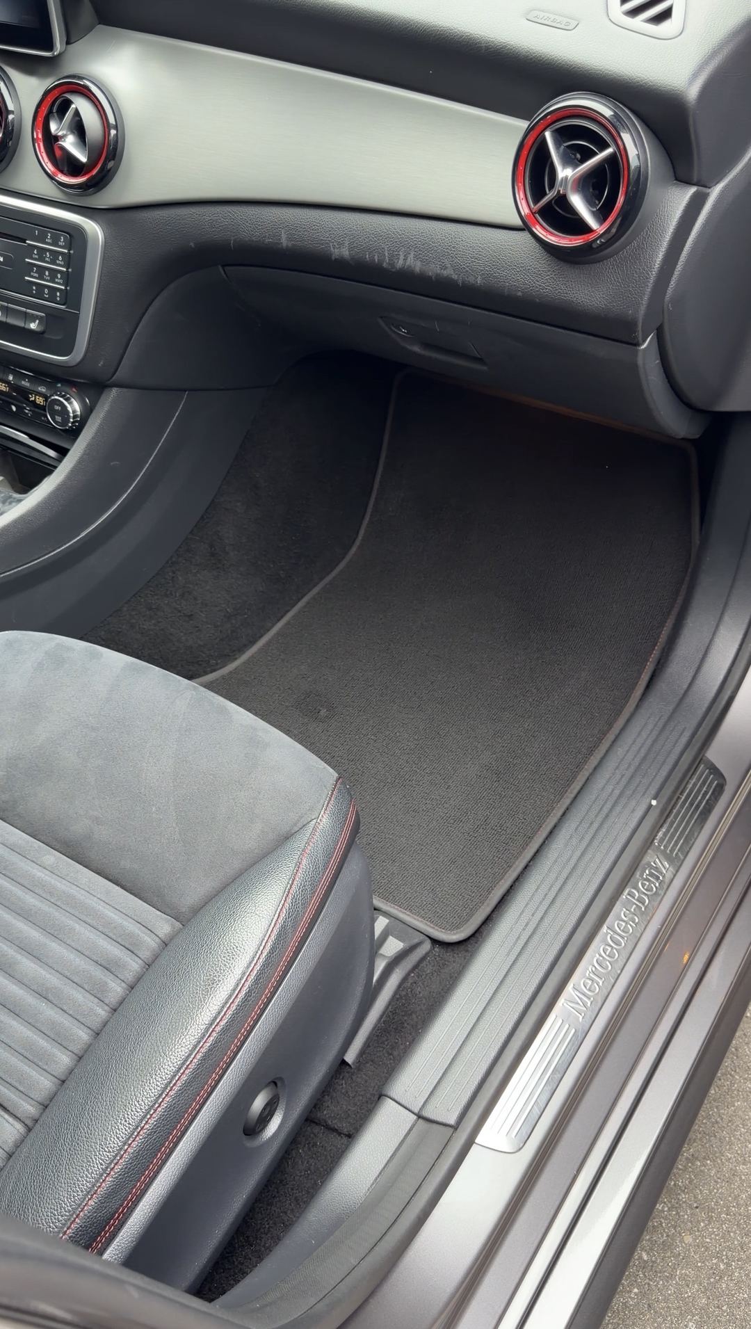 Cleaned front passenger footwell of a grey Mercedes-Benz CLA250 with the illuminated Mercedes-Benz sill plate