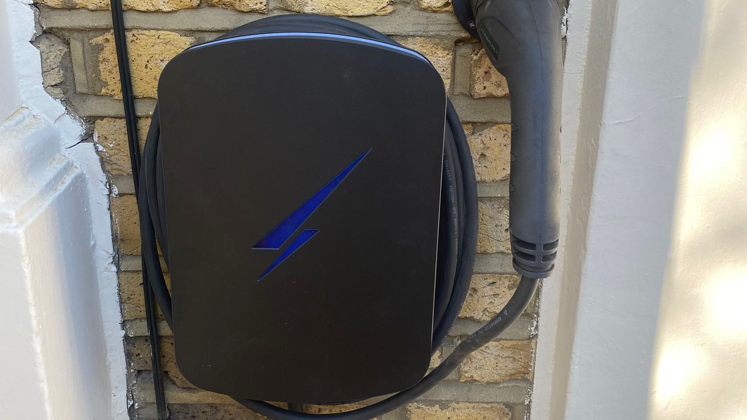 Home EV wall charger unit mounted on exterior brick wall — requires Type A RCD protection Home EV wall charger unit mounted on exterior brick wall — requires Type A RCD protection