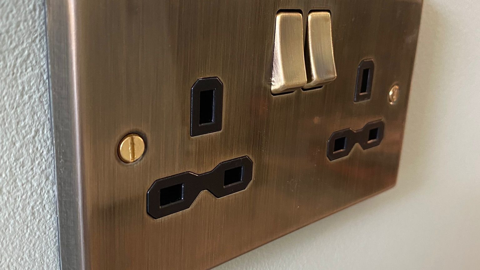 Premium brushed brass UK double socket — quality finish of certified professional electrical installation Premium brushed brass UK double socket — quality finish of certified professional electrical installation