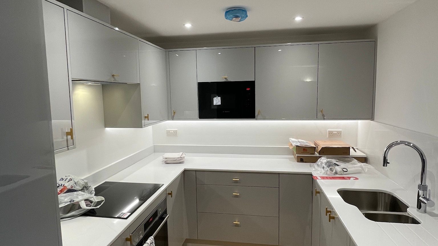 Grey kitchen with recessed LED downlights — energy-efficient ceiling lighting installation
