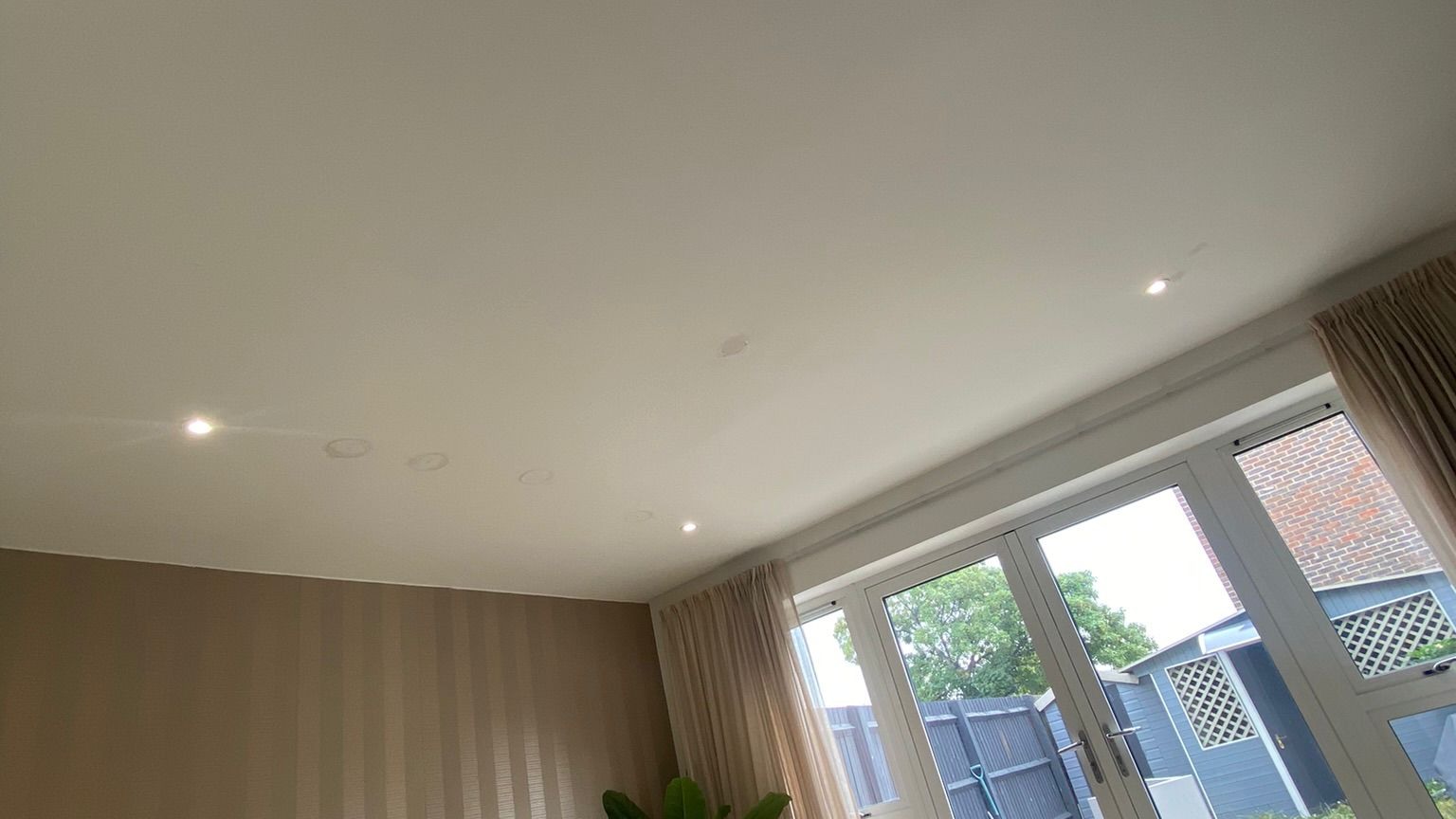 Globe pendant light fitting with warm LED illumination in a living room setting