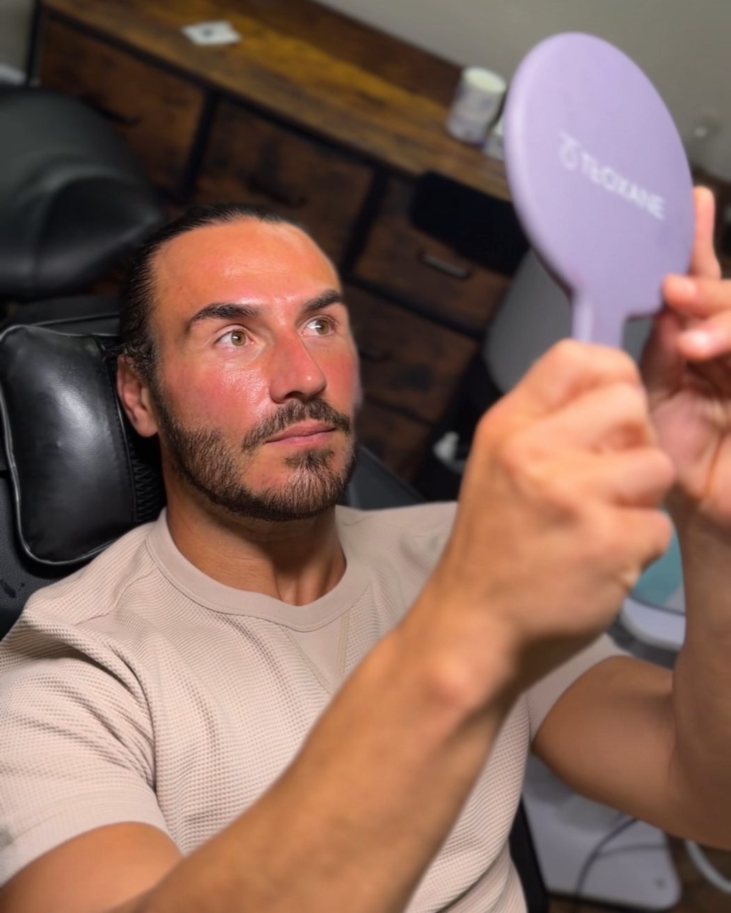 Checking the result in the mirror after treatment at Smile Aesthetics by Jamie