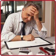 Business professional showing frustration while reviewing documents and using a calculator