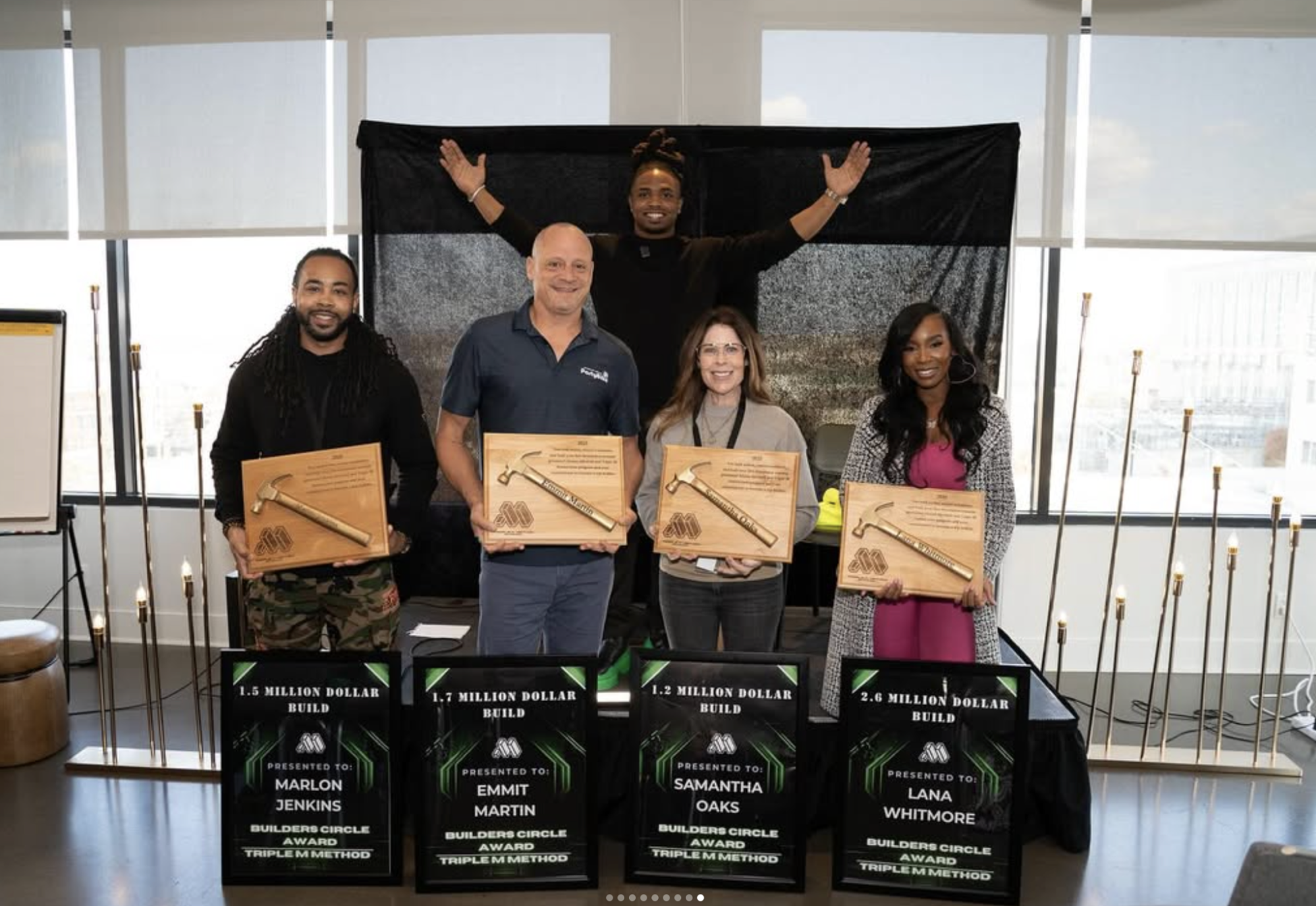 Triple M Method students holding Builders Circle Award plaques for 1.5M, 1.7M, 1.2M and 2.6M dollar builds, with Abram Mitchell celebrating in the background