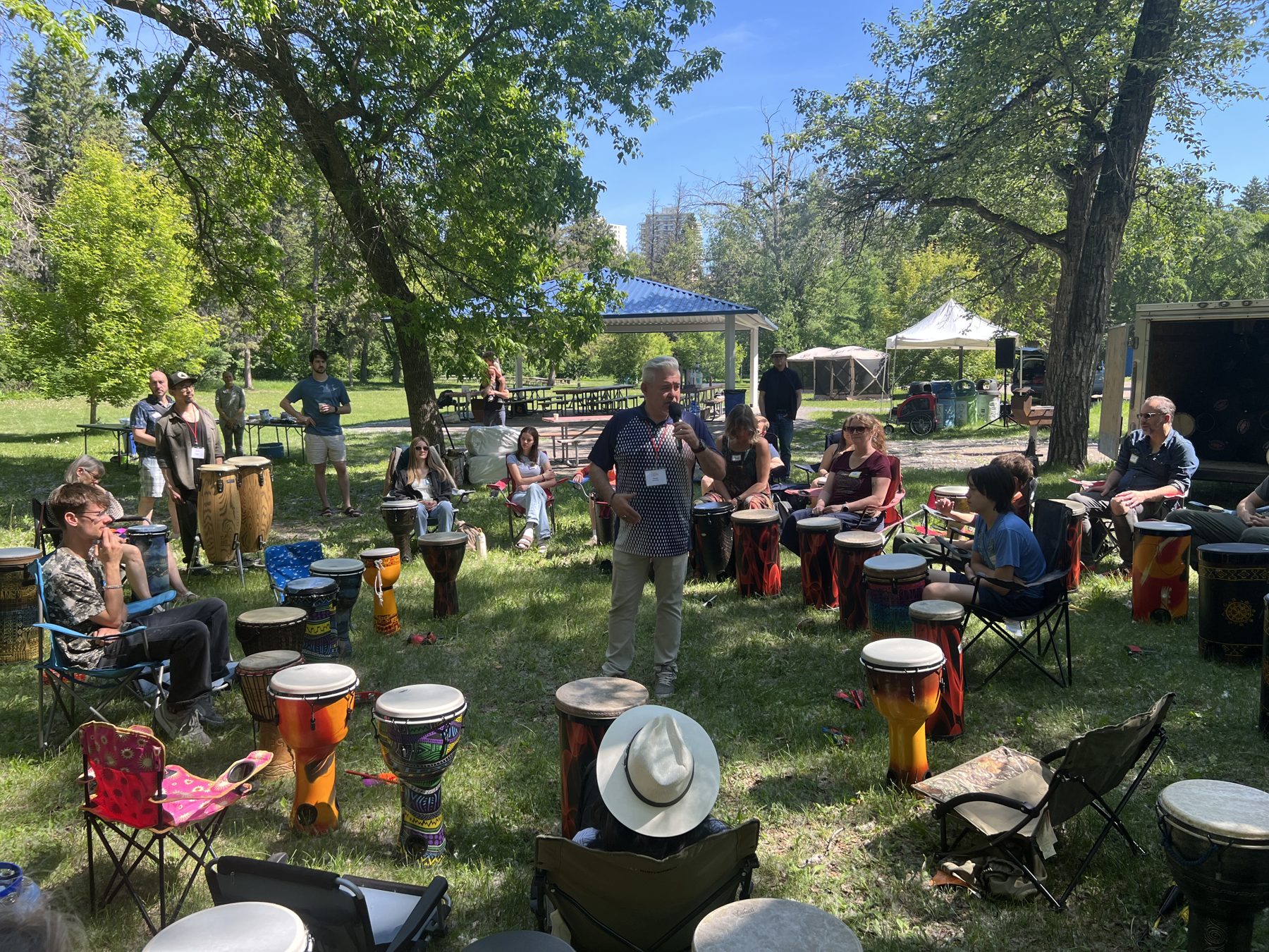 Orest leading an outdoor drum circle with the community
