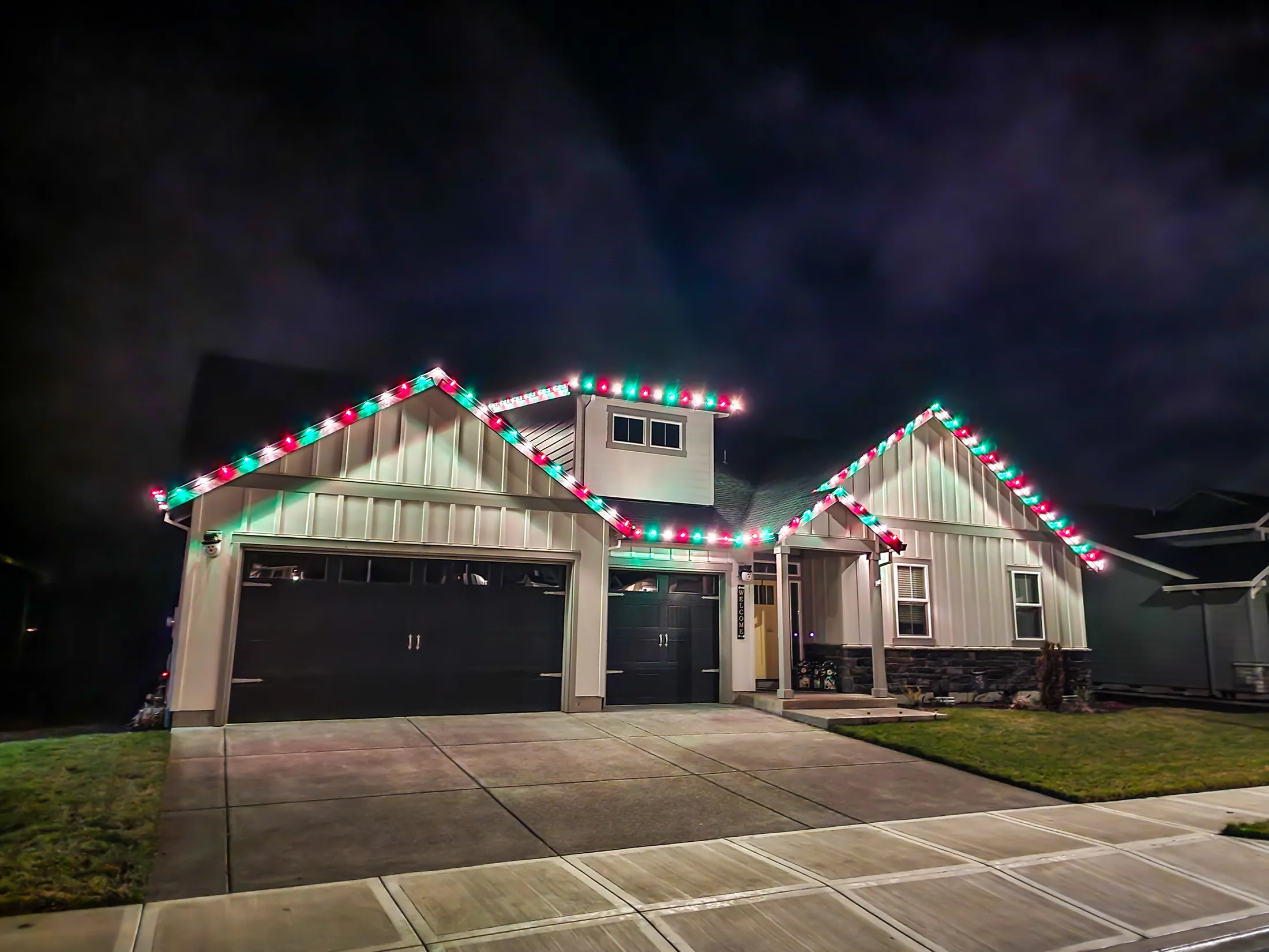 Residential Christmas light installation 13 by Premium Holiday Lights in Salem, OR, warm commercial-grade C9 LED roofline lighting at night