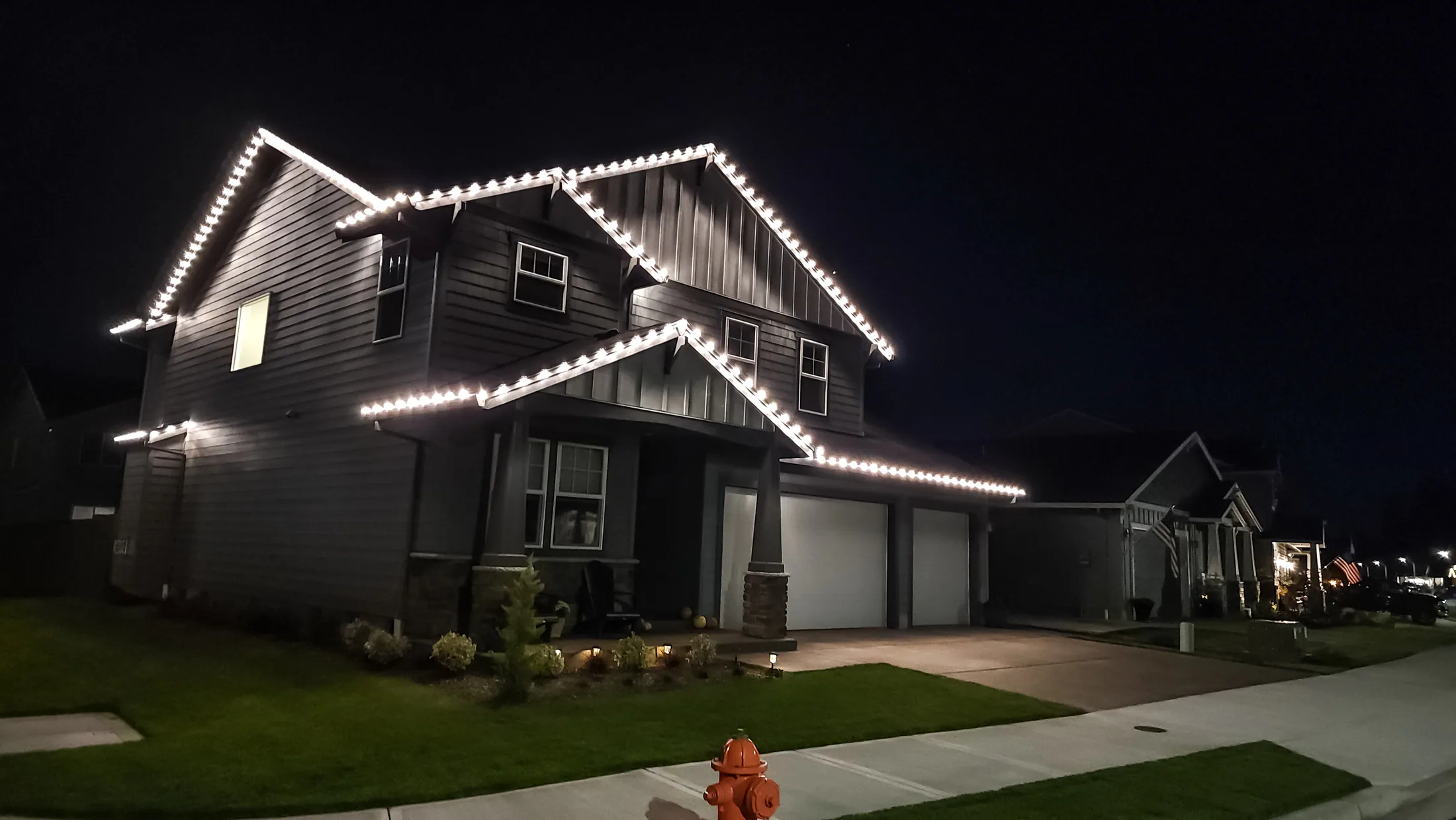 Residential Christmas light installation 21 by Premium Holiday Lights in Salem, OR, warm commercial-grade C9 LED roofline lighting at night
