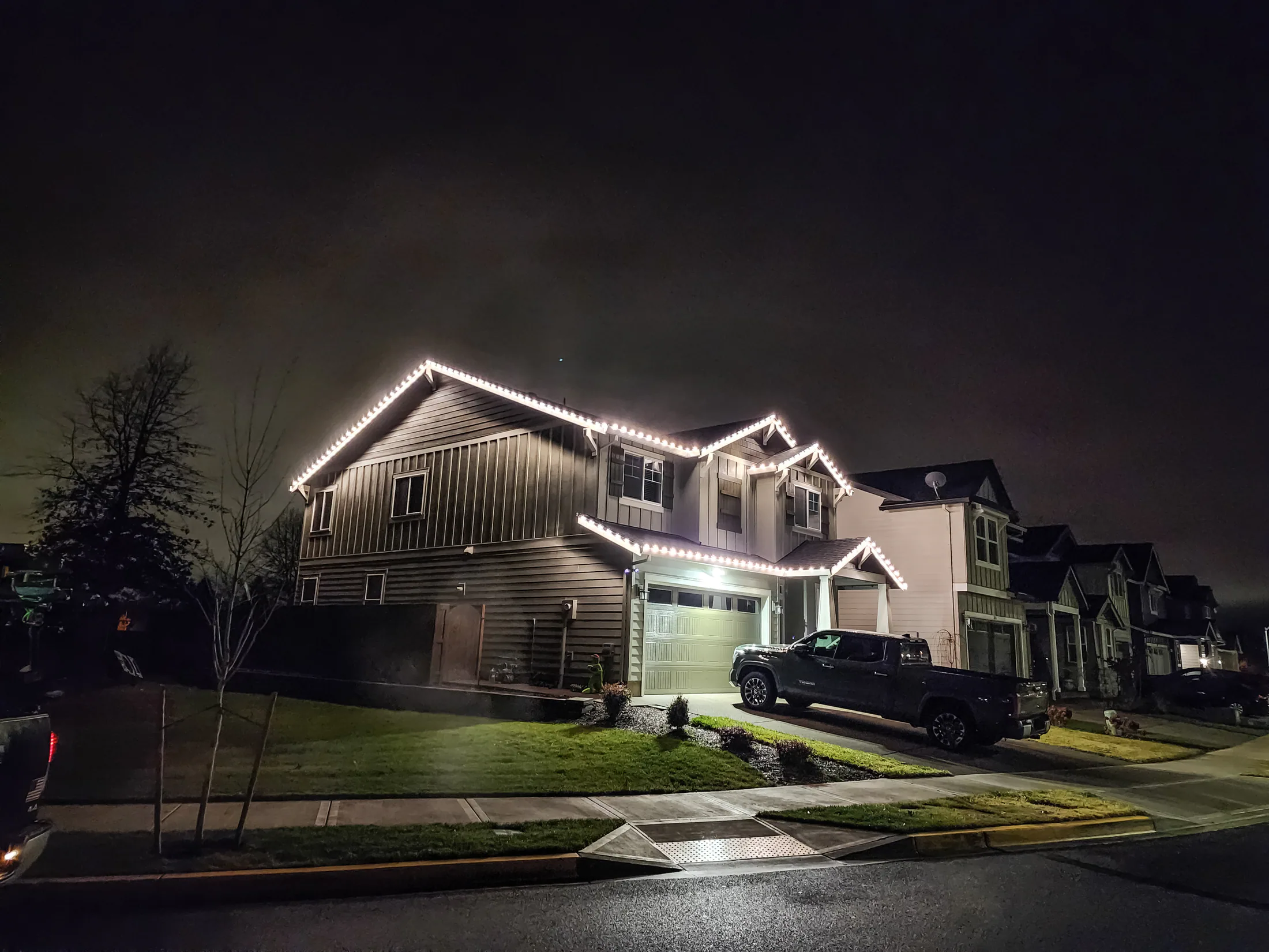 Residential Christmas light installation 22 by Premium Holiday Lights in Salem, OR, warm commercial-grade C9 LED roofline lighting at night