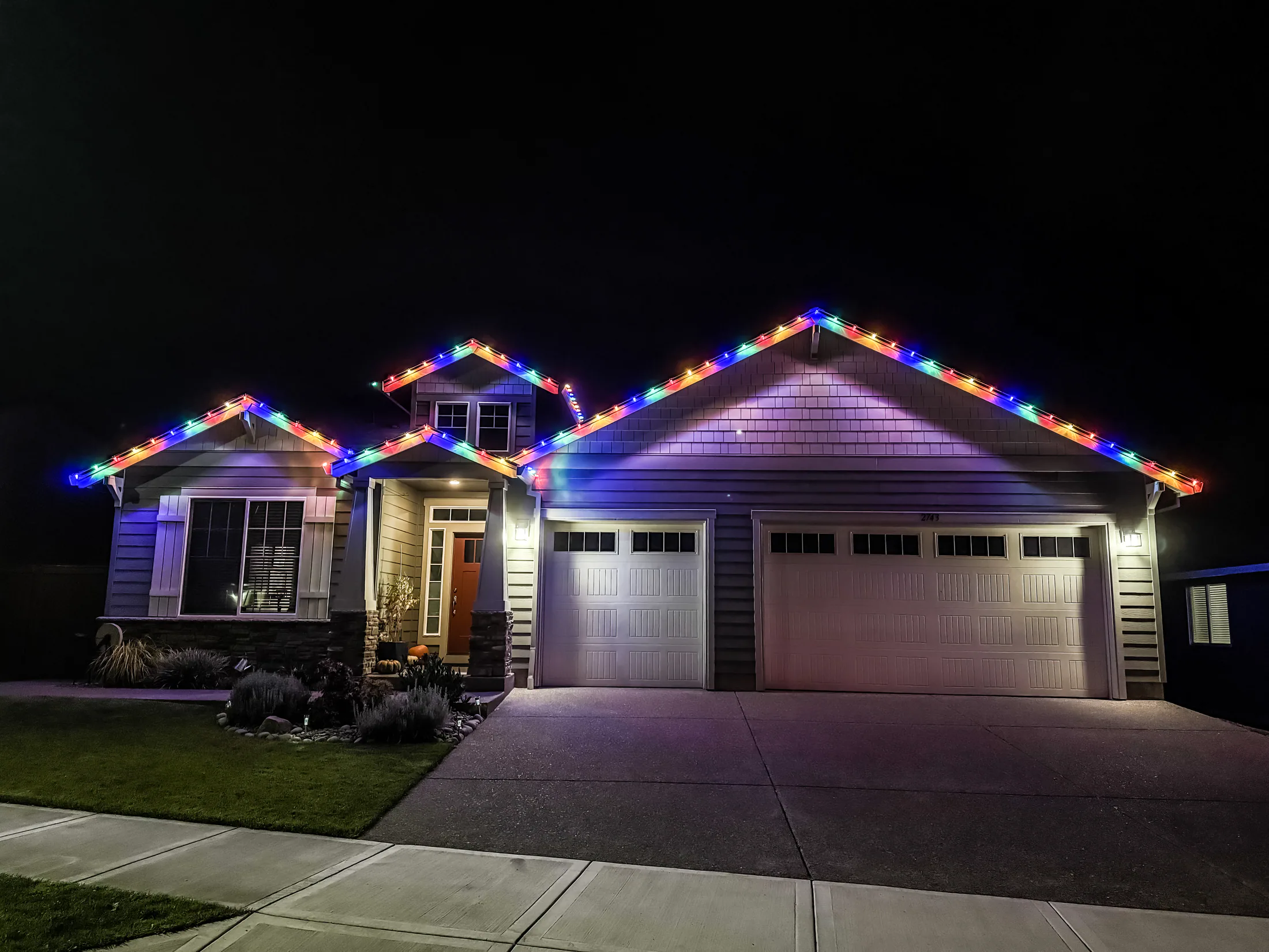 Residential Christmas light installation 30 by Premium Holiday Lights in Salem, OR, warm commercial-grade C9 LED roofline lighting at night