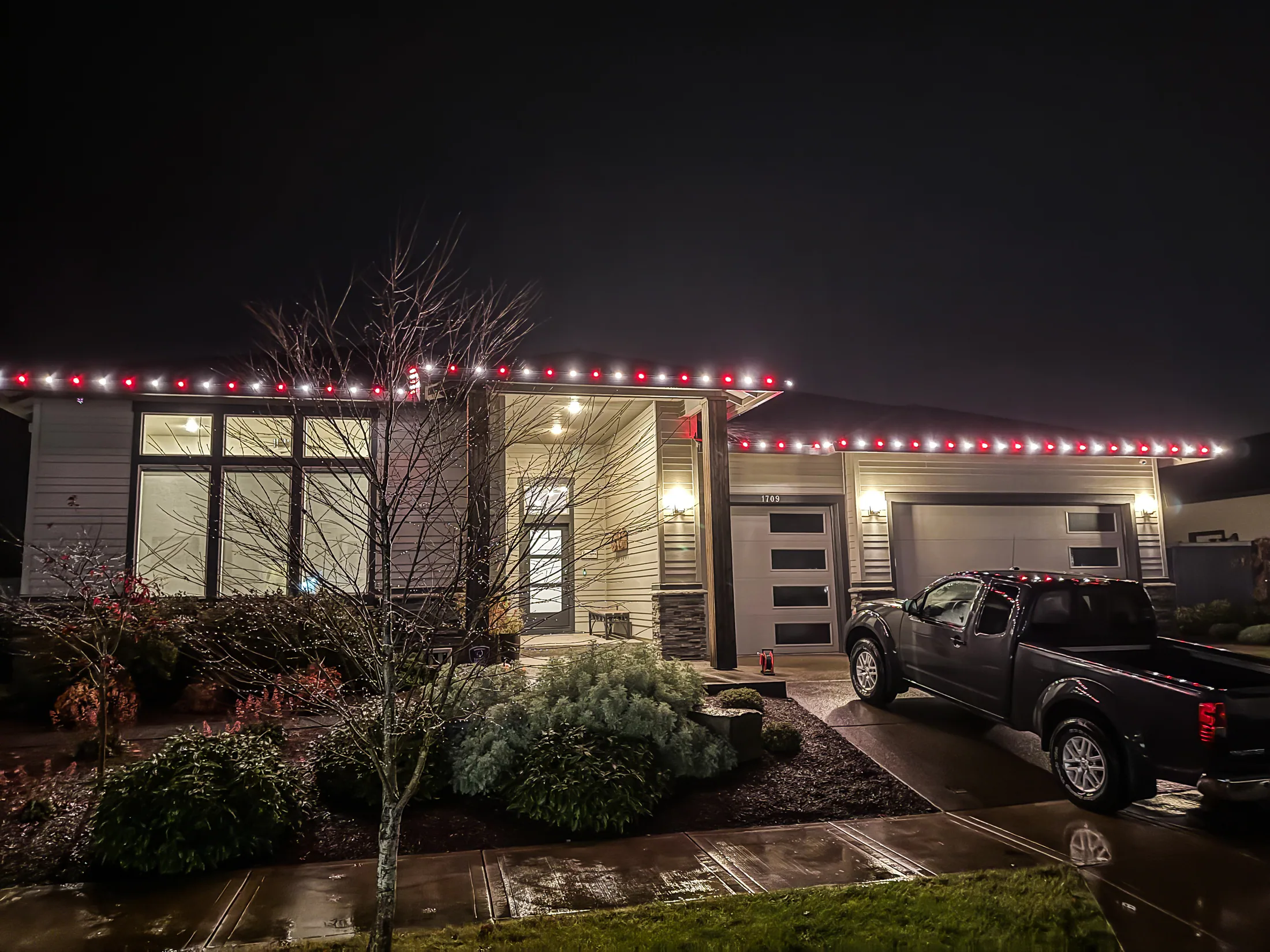 Residential Christmas light installation 39 by Premium Holiday Lights in Salem, OR, warm commercial-grade C9 LED roofline lighting at night