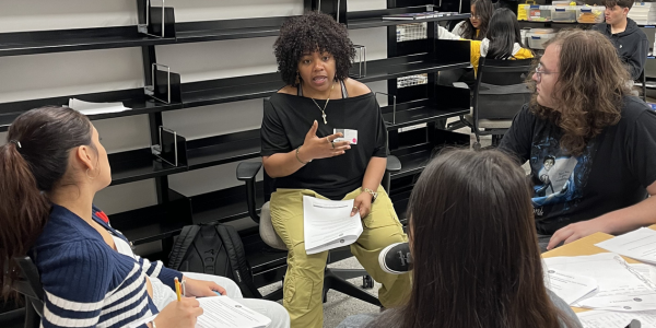 A woman talking in a small group discussion circle