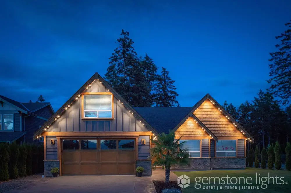 Modern home at night with warm white permanent LED lighting along the roofline