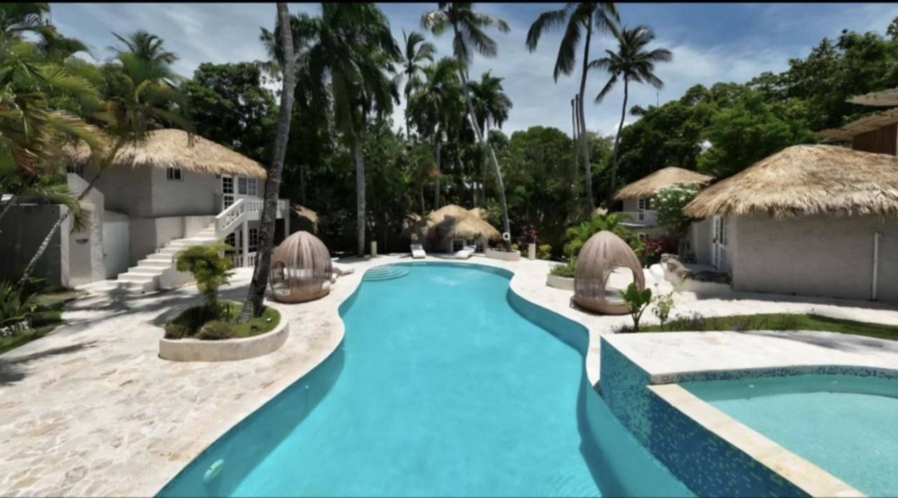 Renovated pool, thatched bungalows and palms at El Kaoba