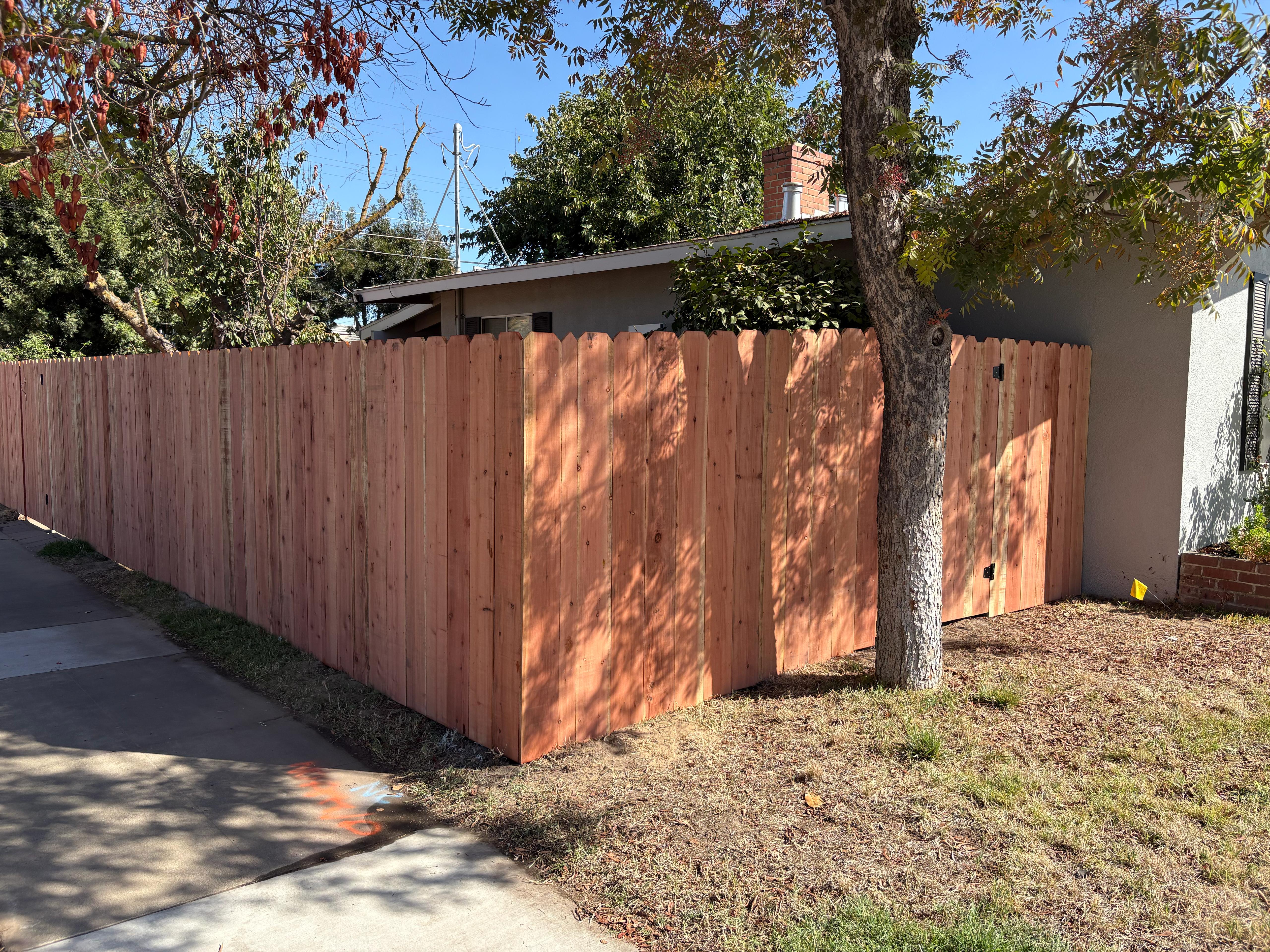 Dog-ear redwood wood fence installation in Perris, California