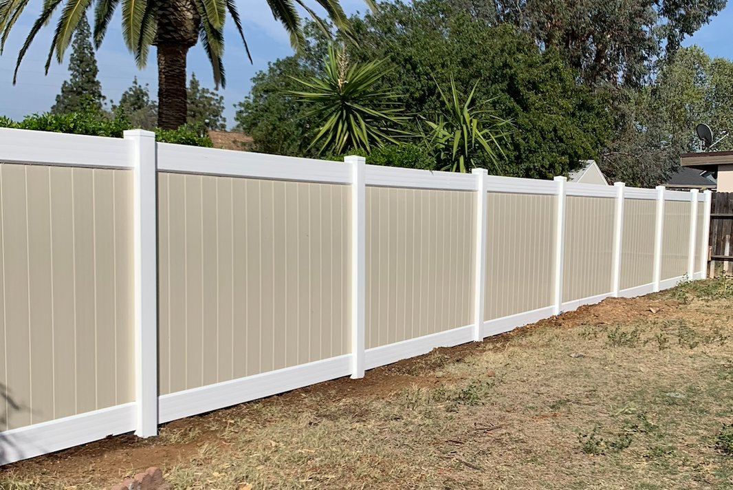 Redwood wood fence along backyard lawn in Perris, California