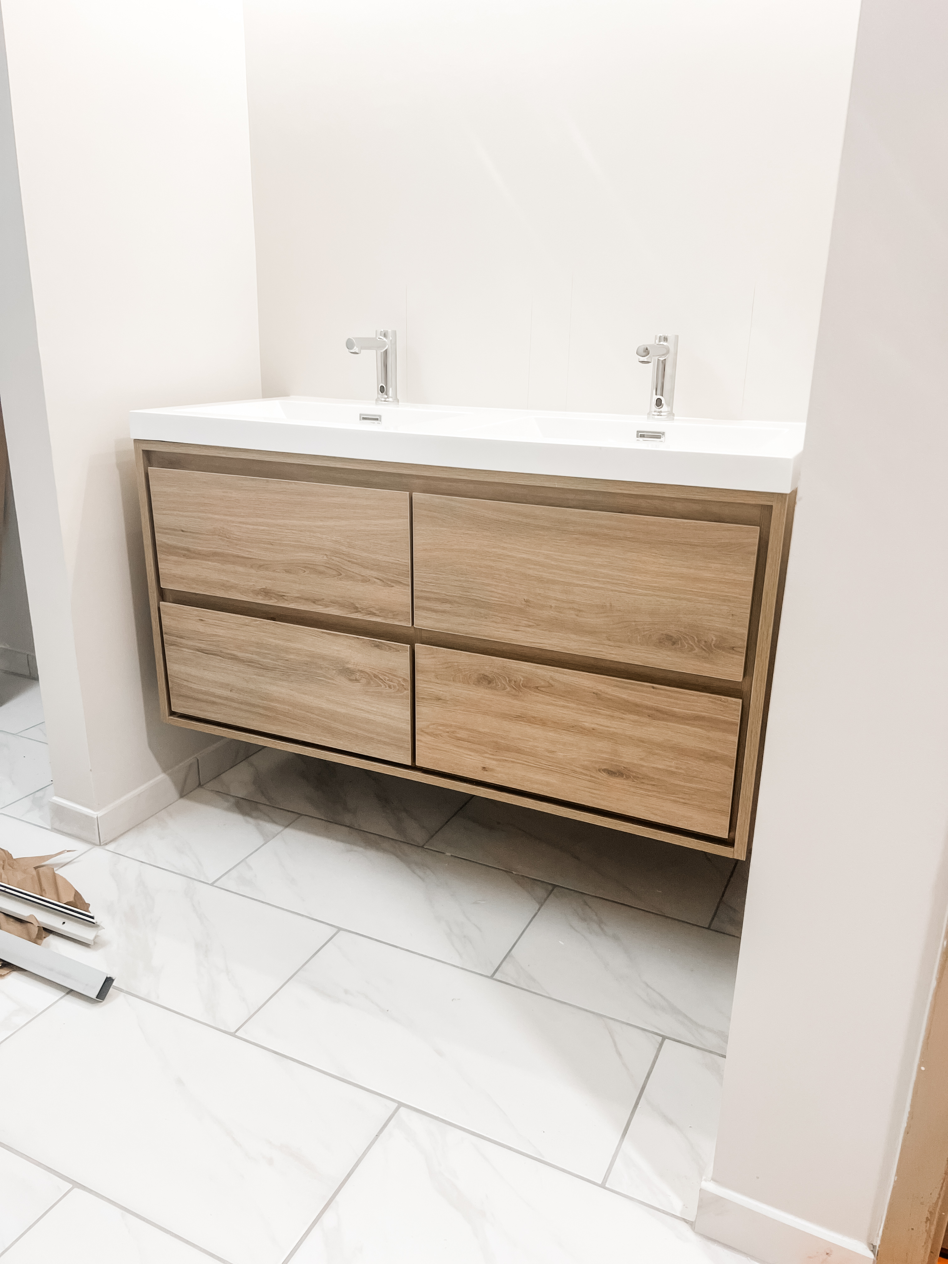 Floating double sink vanity with wood drawers and minimalist modern design
