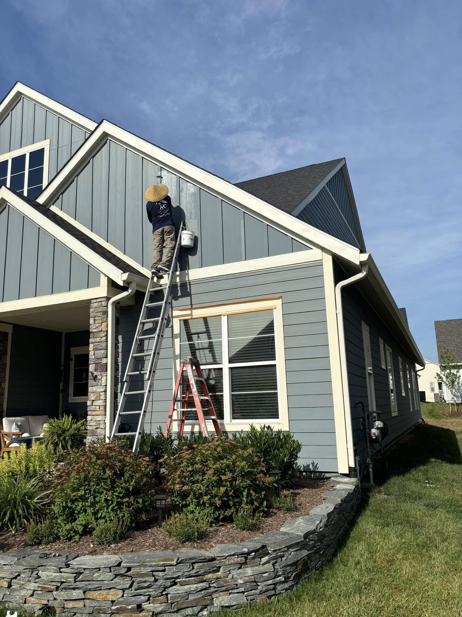 AC Solutions & More team member completing exterior painting on a residential home in Frederick County, VA