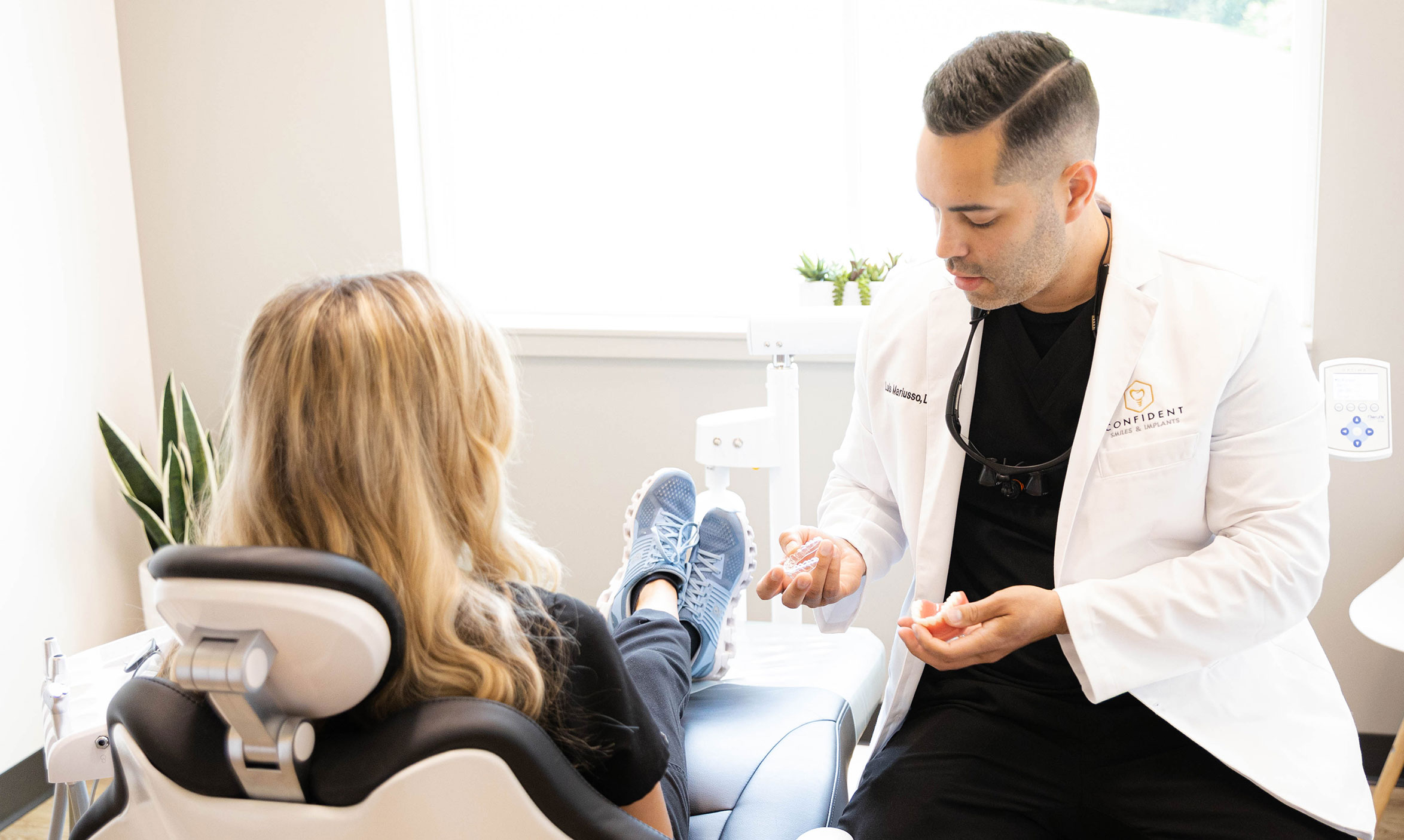 Woman holding invisalign