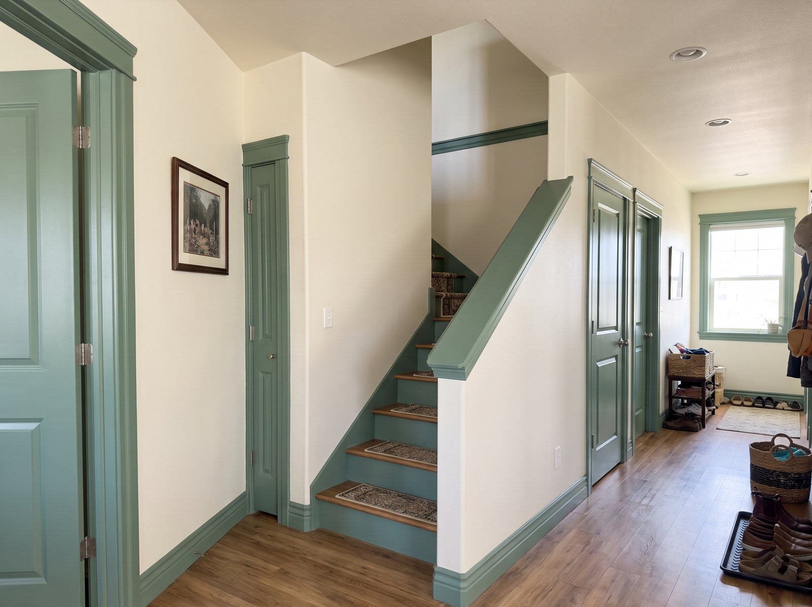 Hallway and staircase with cream walls and trim, doors and stair risers painted Webster Green Hallway and staircase with cream walls and trim, doors and stair risers painted Webster Green