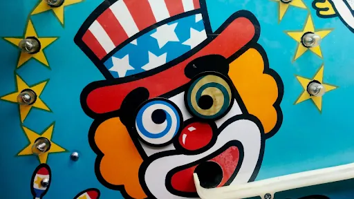 Brightly painted mural of a clown wearing a stars-and-stripes top hat