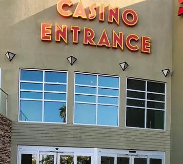 A commercial building entrance where one bank of windows has been tinted and the neighbouring banks have not, showing the difference on the same facade.