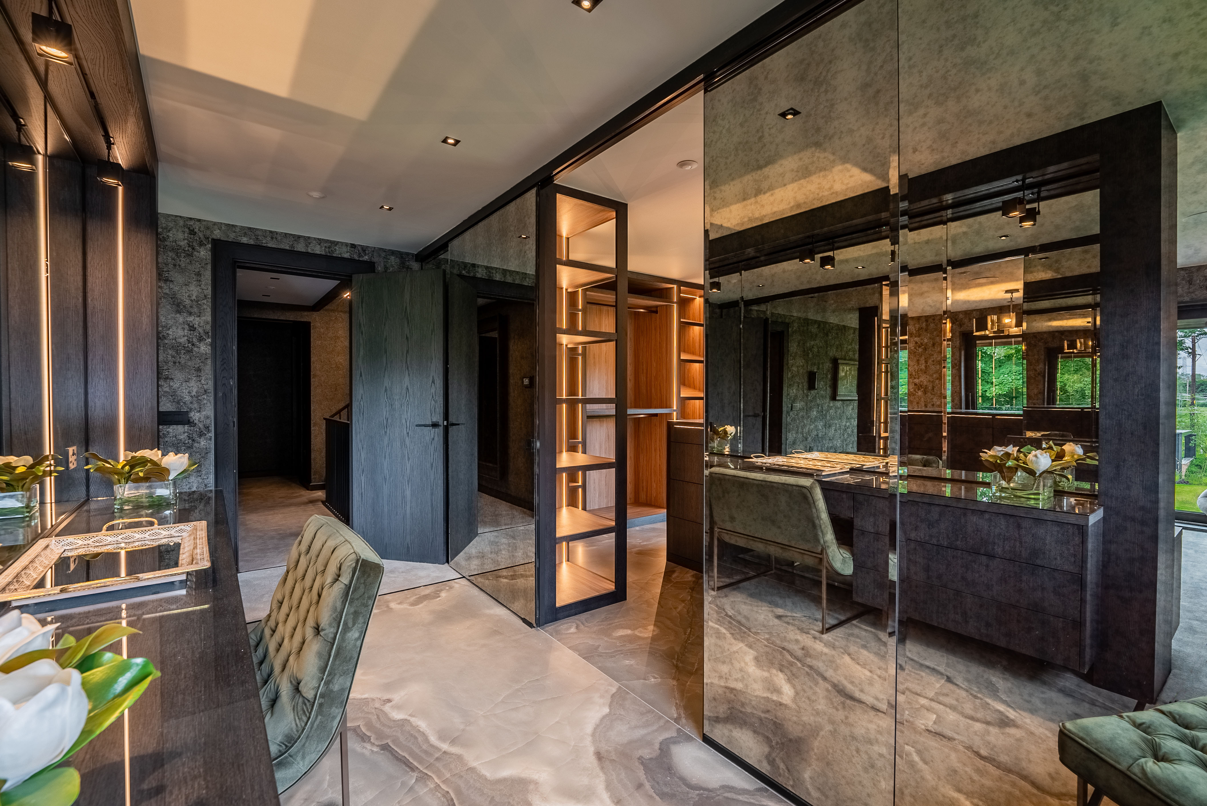 Floor-to-ceiling smoked mirror wall in dressing room