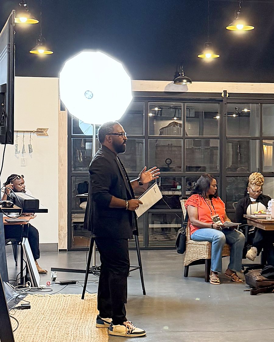 Michael Amey teaching at City First LA, notes in hand, pastors seated and listening