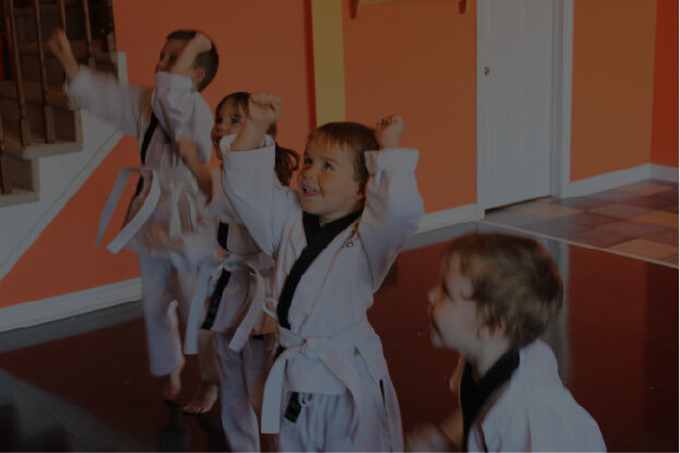 young children and toddlers excited to be learning karate