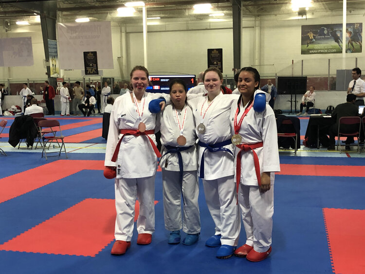 a team of 4 karate students attending a tournament