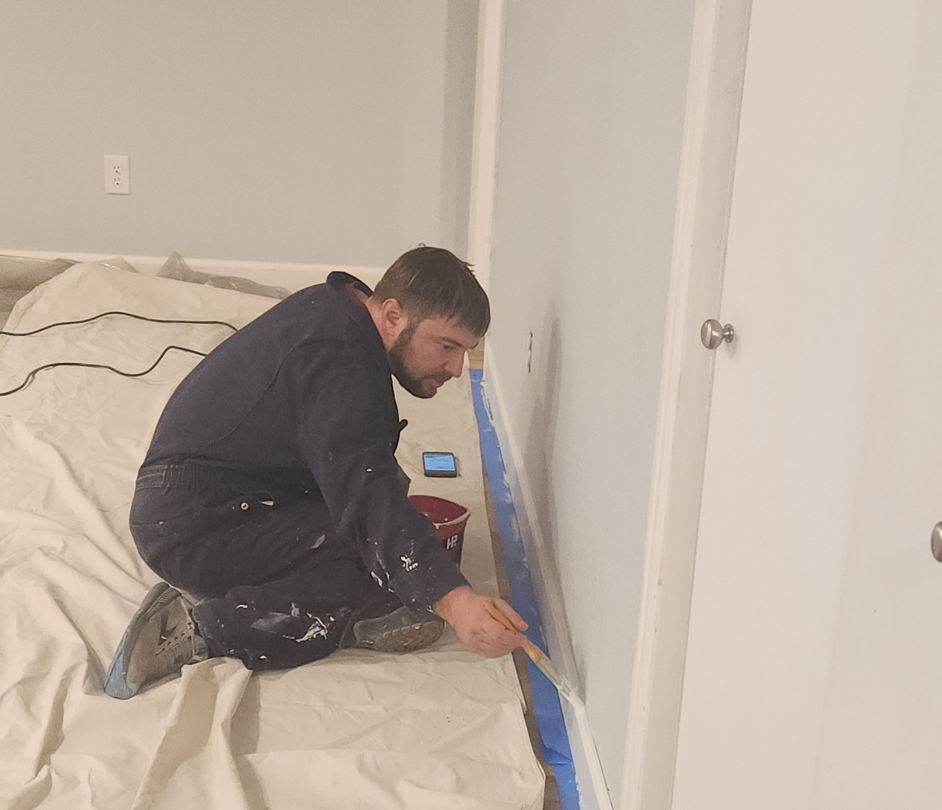 Big Wheel Handyman professional applying a finish coat of paint to a smooth drywall repair in a Denver home to ensure a seamless match. Big Wheel Handyman professional applying a finish coat of paint to a smooth drywall repair in a Denver home to ensure a seamless match.