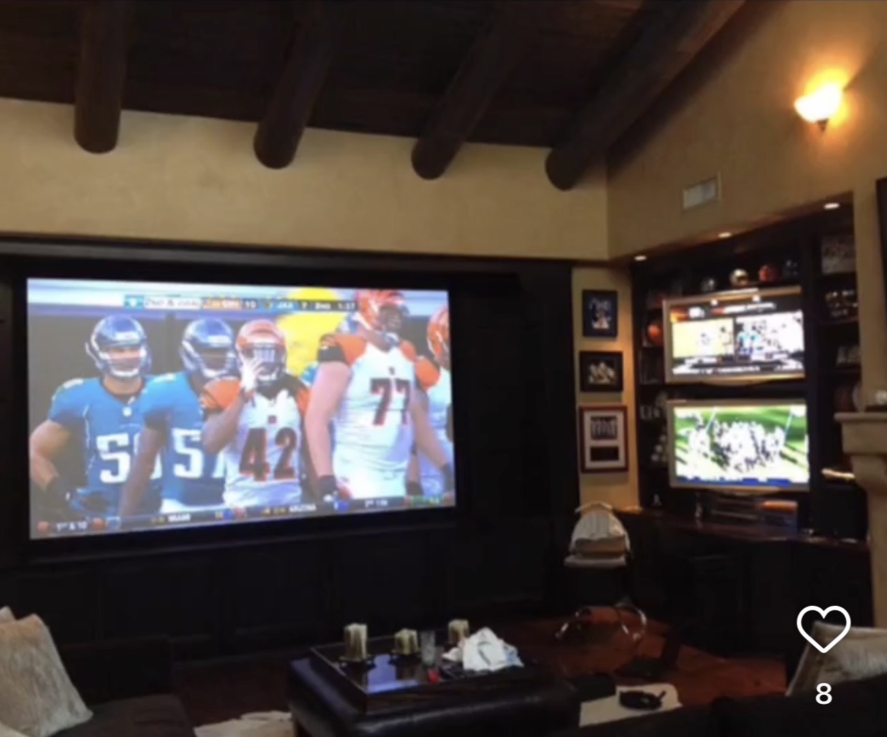 Nick Lachey home theater with a 134-inch projection screen and two 42-inch side TVs
